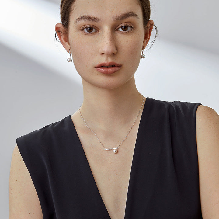 Akoya pearl 18K white gold moon-shaped diamond necklace from Reflection Collection, showcasing a elegant pearl and diamond pendant.