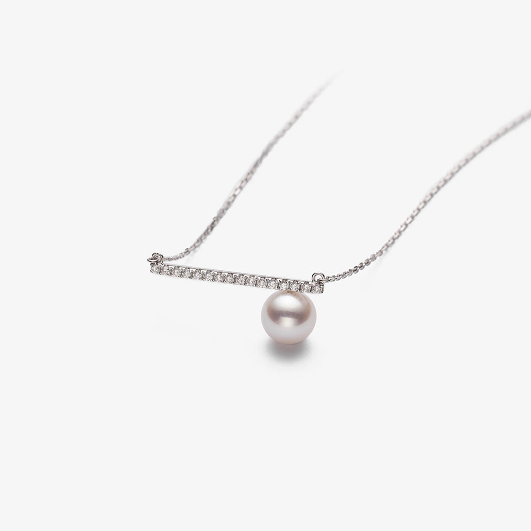 Akoya pearl and moon-shaped diamond necklace in 18K white gold from Reflection Collection, close-up of the elegant jewelry piece.