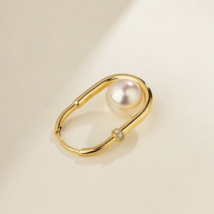 Close-up of freshwater pearl in gold vermeil U-shaped hoop earring with lab-grown diamond accent