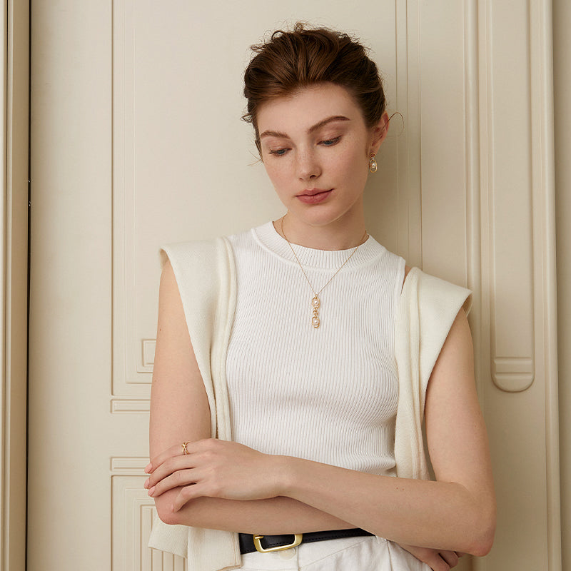 Model styled with gold vermeil freshwater pearl earrings and matching pendant necklace
