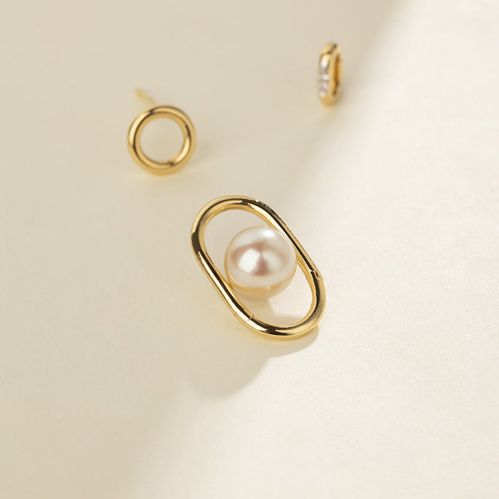 Gold vermeil freshwater pearl oval earring components laid flat, modular interlocking design detail