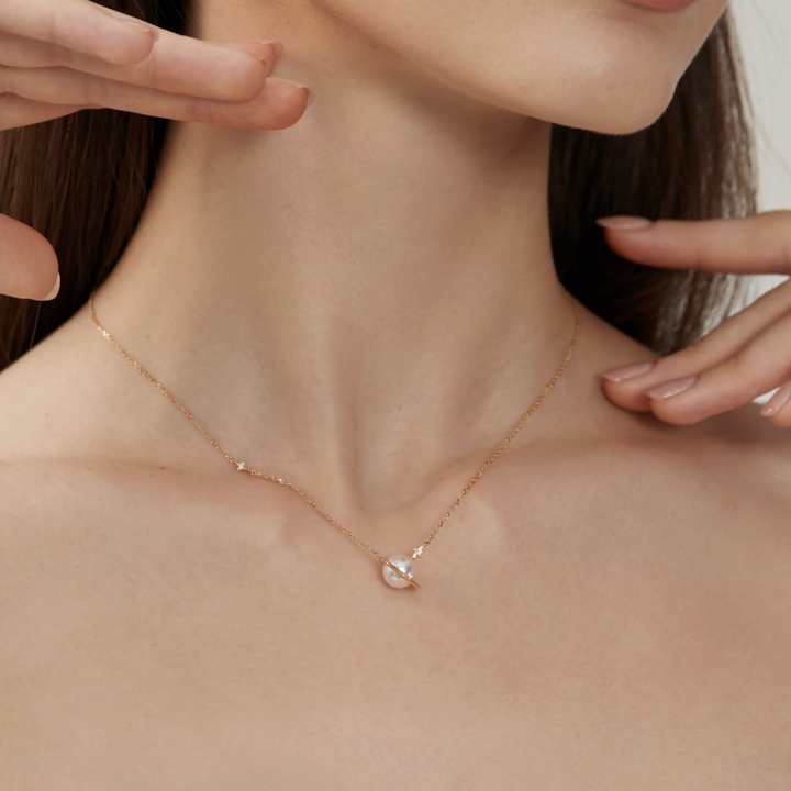 Saltwater pearl 18K gold diamond planet necklace from Star Trails Collection showcasing a celestial-inspired jewelry design.