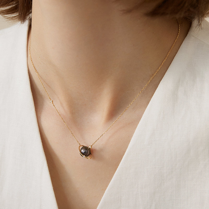 Saltwater pearl and diamond planet necklace in 18K gold from Star Trails Collection, featuring a celestial-inspired pendant.