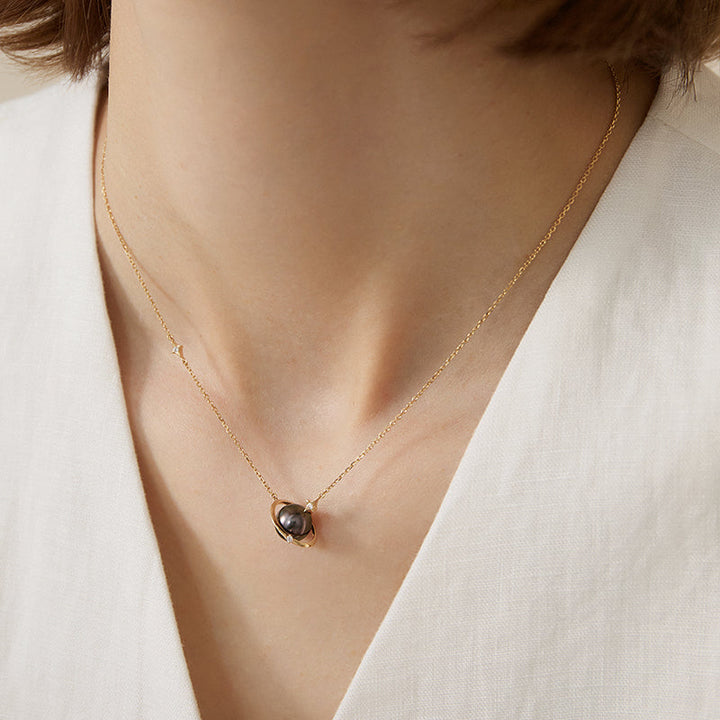 Saltwater pearl and diamond planet necklace in 18K gold from Star Trails Collection, featuring a celestial-inspired pendant.