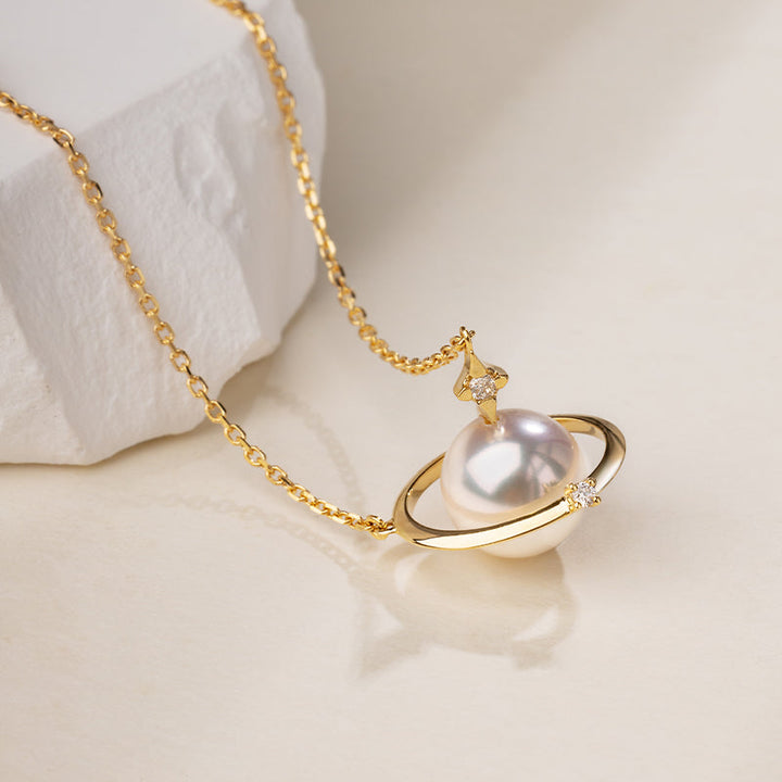 Saltwater Pearl and 18K gold diamond planet necklace from Star Trails Collection, showcasing a celestial-inspired jewelry design.