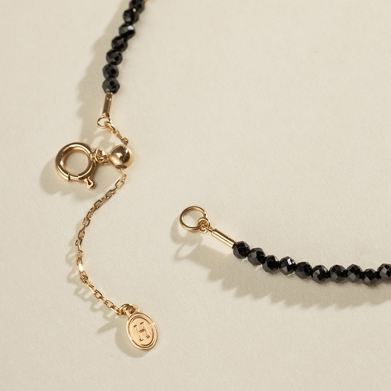 Gold vermeil spring ring clasp and adjustable extension chain detail on black spinel freshwater pearl bracelet