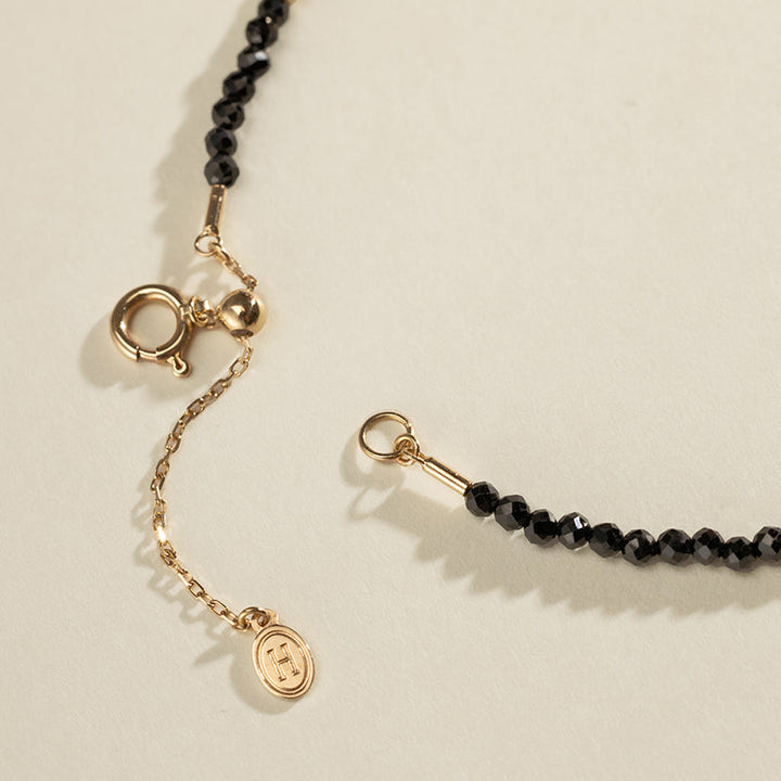 Gold vermeil spring ring clasp and adjustable extension chain detail on black spinel freshwater pearl bracelet
