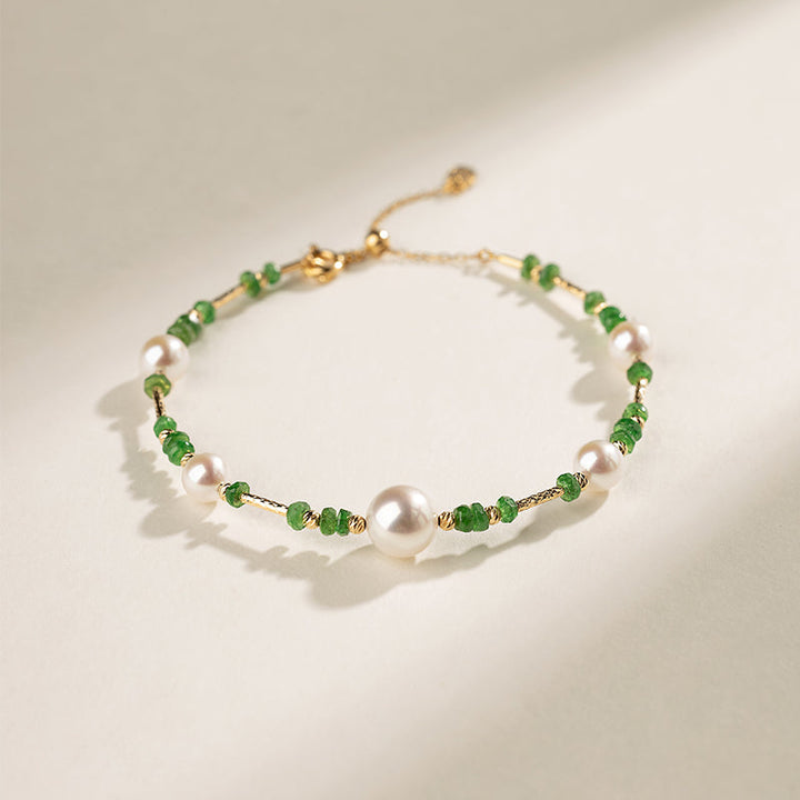 Gold vermeil freshwater pearl and tsavorite baby's breath bracelet, flat lay
