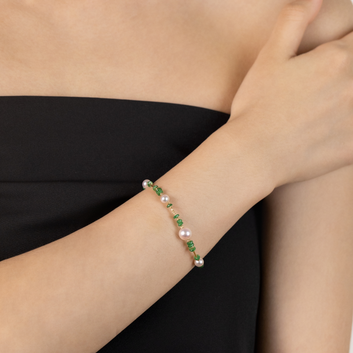 Model wearing freshwater pearl tsavorite gold vermeil bracelet, side wrist view