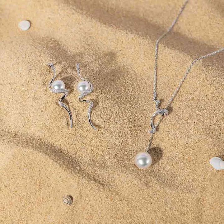 Freshwater pearl sterling silver diamond Y-shaped lariat necklace and matching earrings set, styled on sand