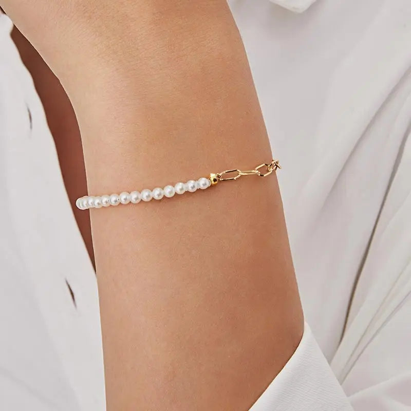 Model wearing freshwater pearl gold vermeil half chain bracelet on wrist, front view