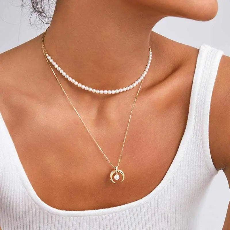 Model styling freshwater pearl gold vermeil necklace layered with pendant necklace