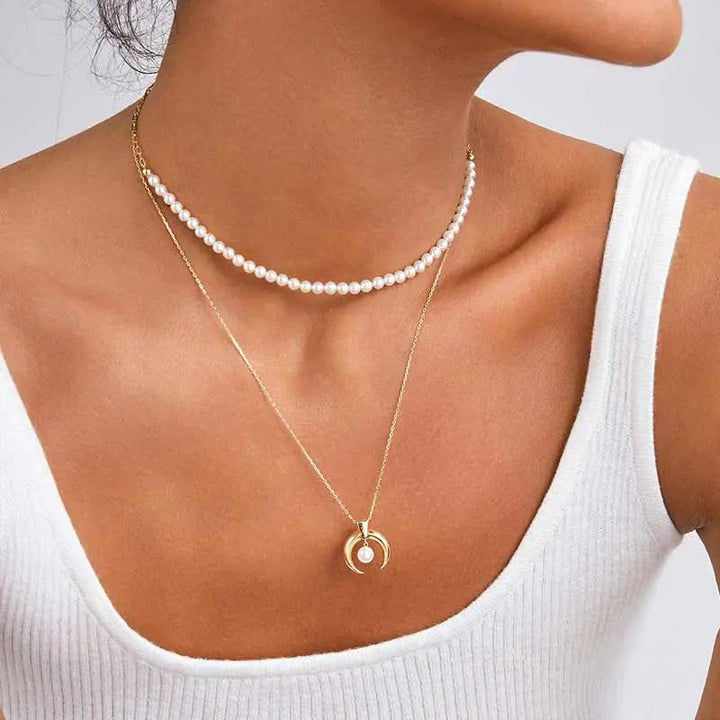 Model styling freshwater pearl gold vermeil necklace layered with pendant necklace